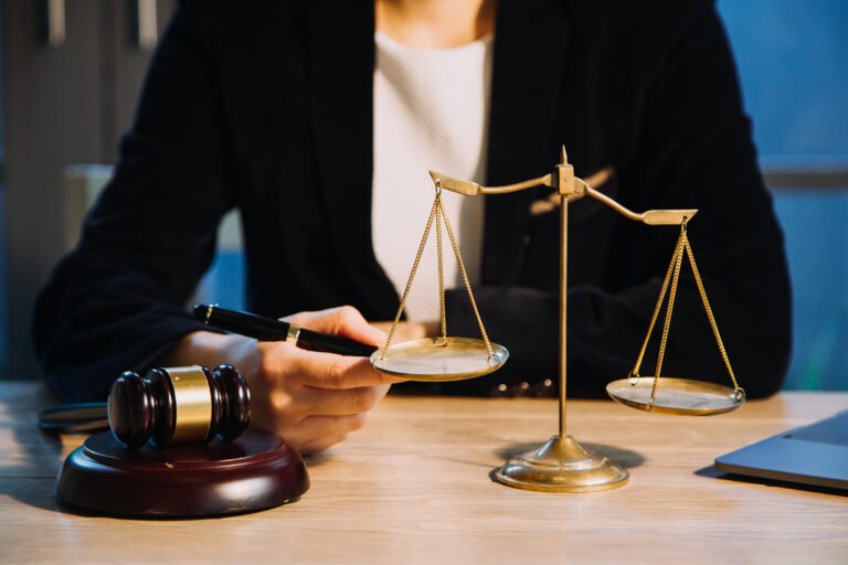 justice-law-conceptmale-judge-courtroom-with-gavel-working-with-computer-docking-keyboard-eyeglasses-table-morning-light